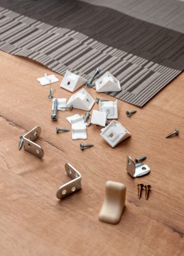 shelf mounts and self-tapping screws on the wooden surface